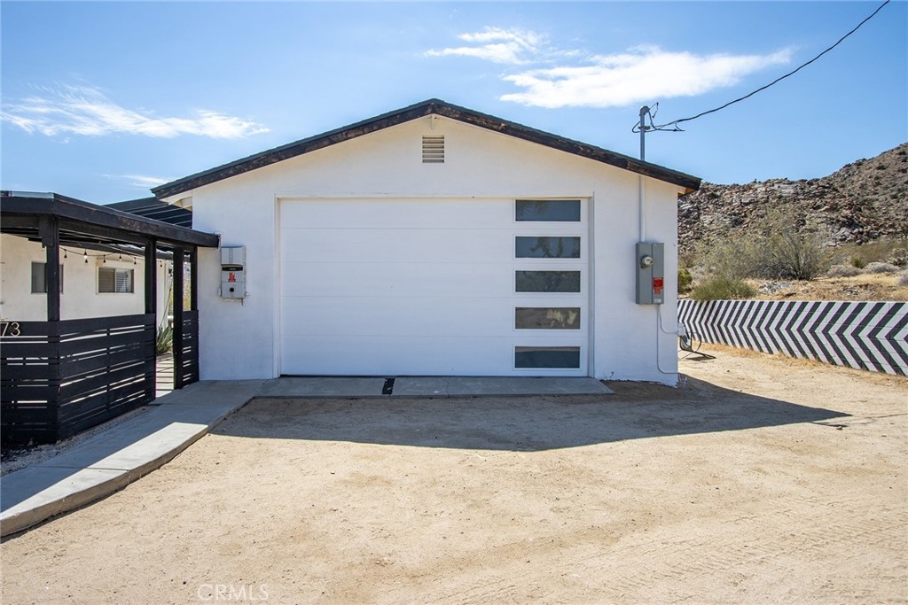 9073 Tortuga Trail Joshua Tree, CA 92252 - Photo 26 of 39 a view of a house with a garage