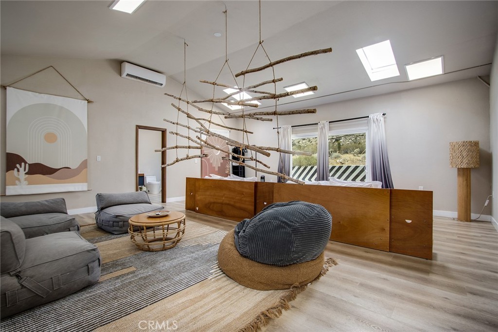 9073 Tortuga Trail Joshua Tree, CA 92252 - Photo 28 of 39 a living room with furniture and a wooden floor