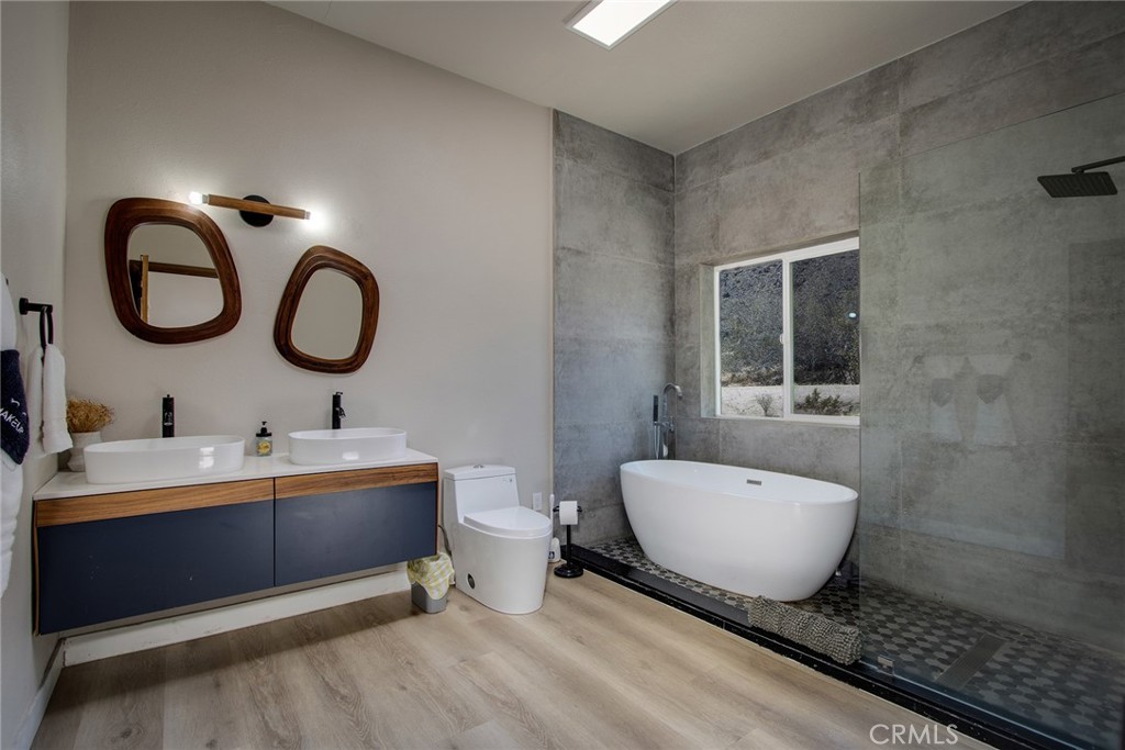 9073 Tortuga Trail Joshua Tree, CA 92252 - Photo 31 of 39 a spacious bathroom with a double vanity sink and a mirror