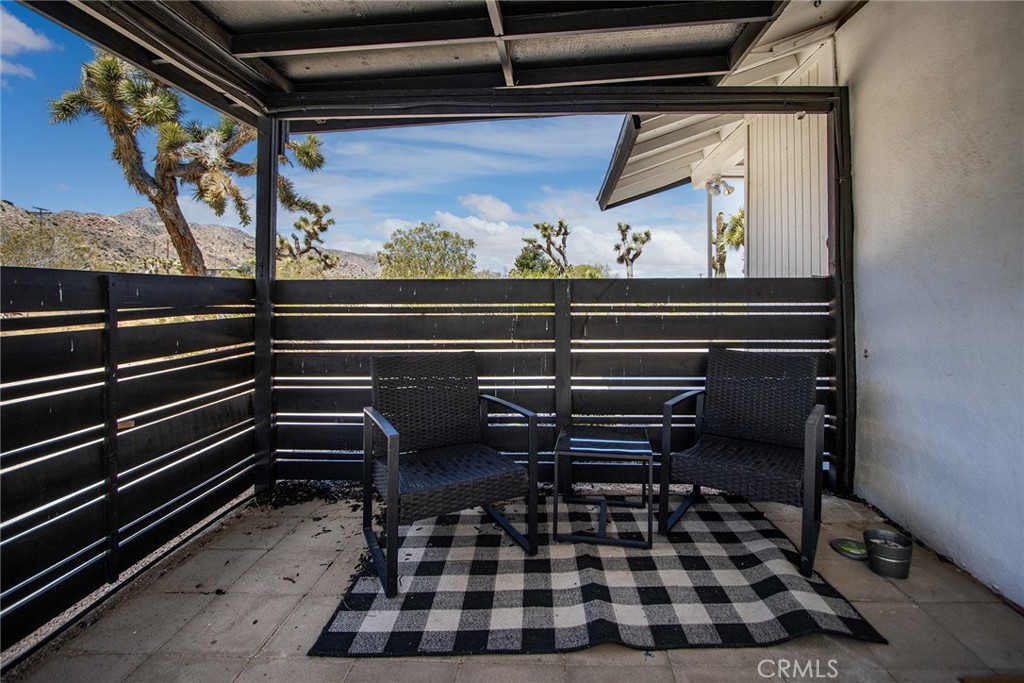 9073 Tortuga Trail Joshua Tree, CA 92252 - Photo 34 of 39 a black and white checkered floor with a rug