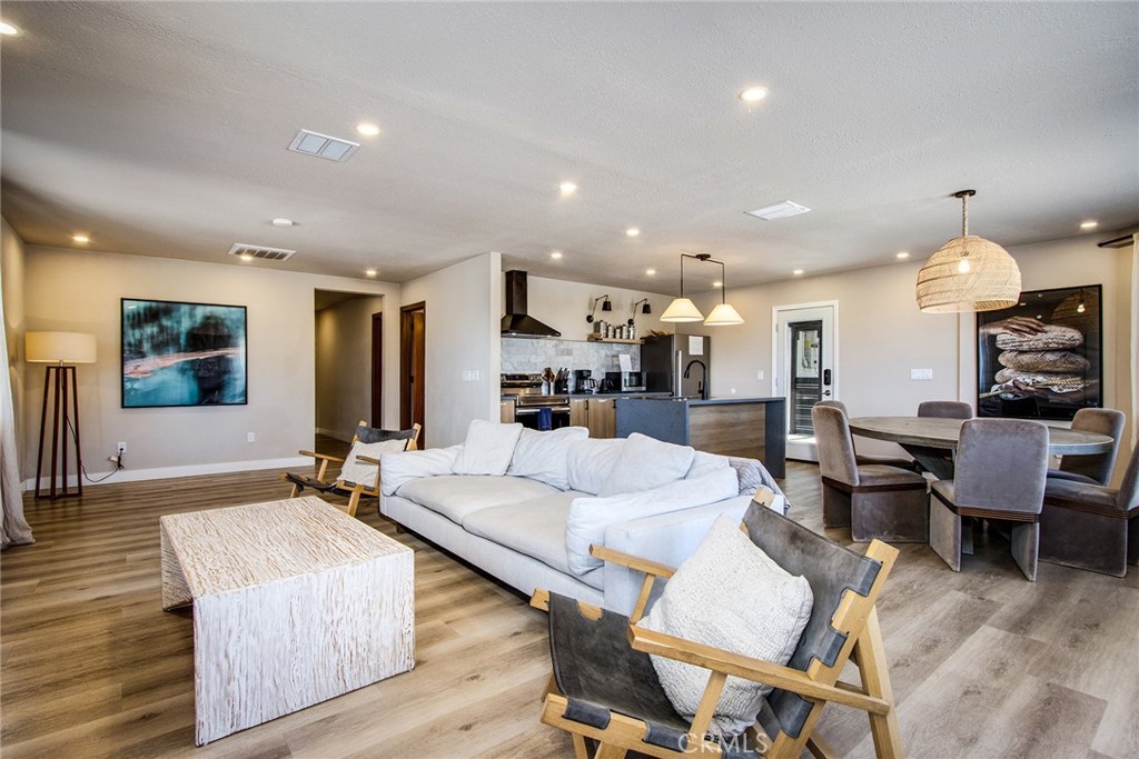 9073 Tortuga Trail Joshua Tree, CA 92252 - Photo 5 of 39 a living room with furniture kitchen view and a wooden floor