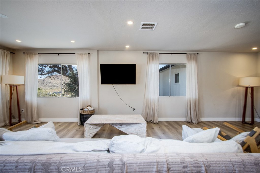 9073 Tortuga Trail Joshua Tree, CA 92252 - Photo 6 of 39 a bedroom with a bed and a flat screen tv