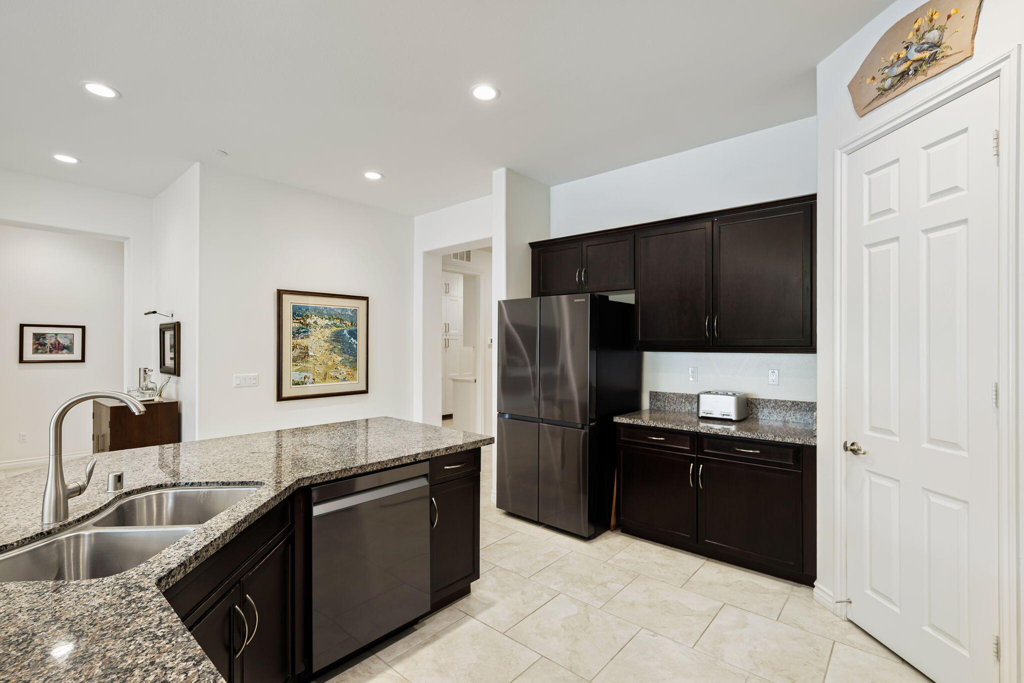 85568 Brovello Drive Indio, CA 92203 - Photo 11 of 50 a kitchen with granite countertop a refrigerator and a sink