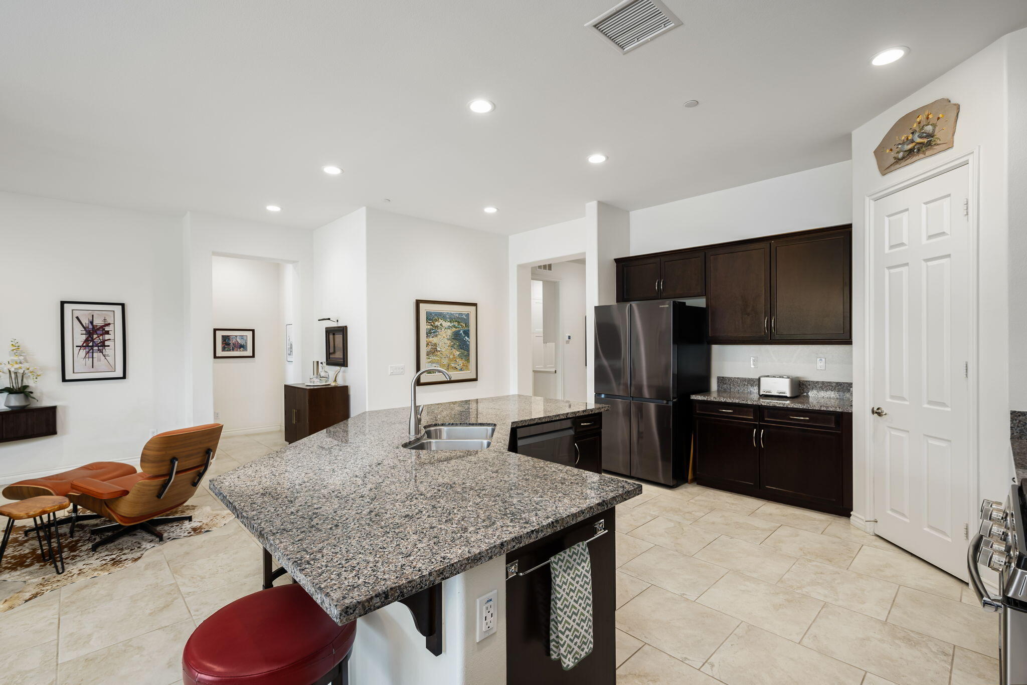 85568 Brovello Drive Indio, CA 92203 - Photo 12 of 50 a kitchen with stainless steel appliances granite countertop a refrigerator and stove