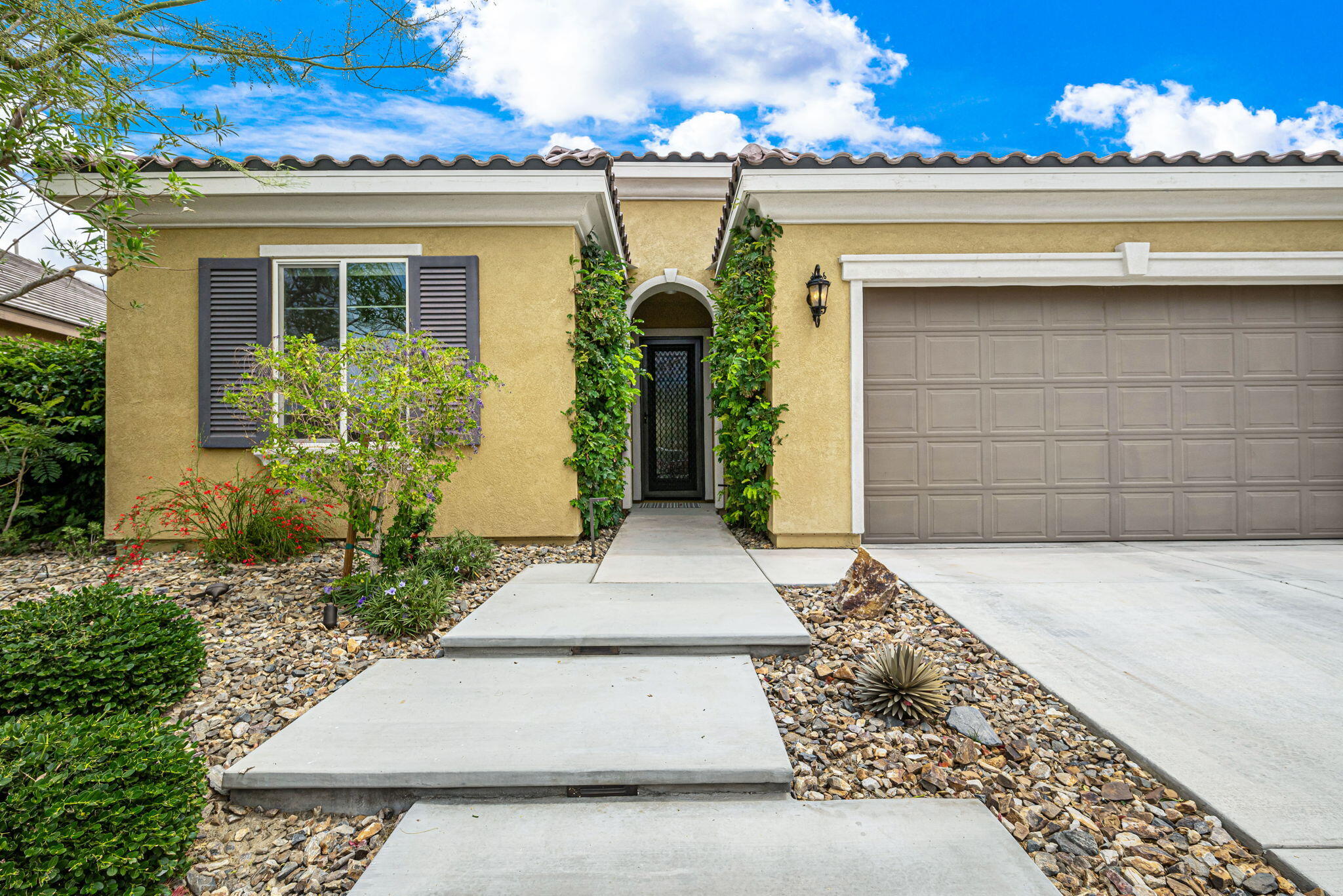 85568 Brovello Drive Indio, CA 92203 - Photo 2 of 50 front view of a house with potted plants