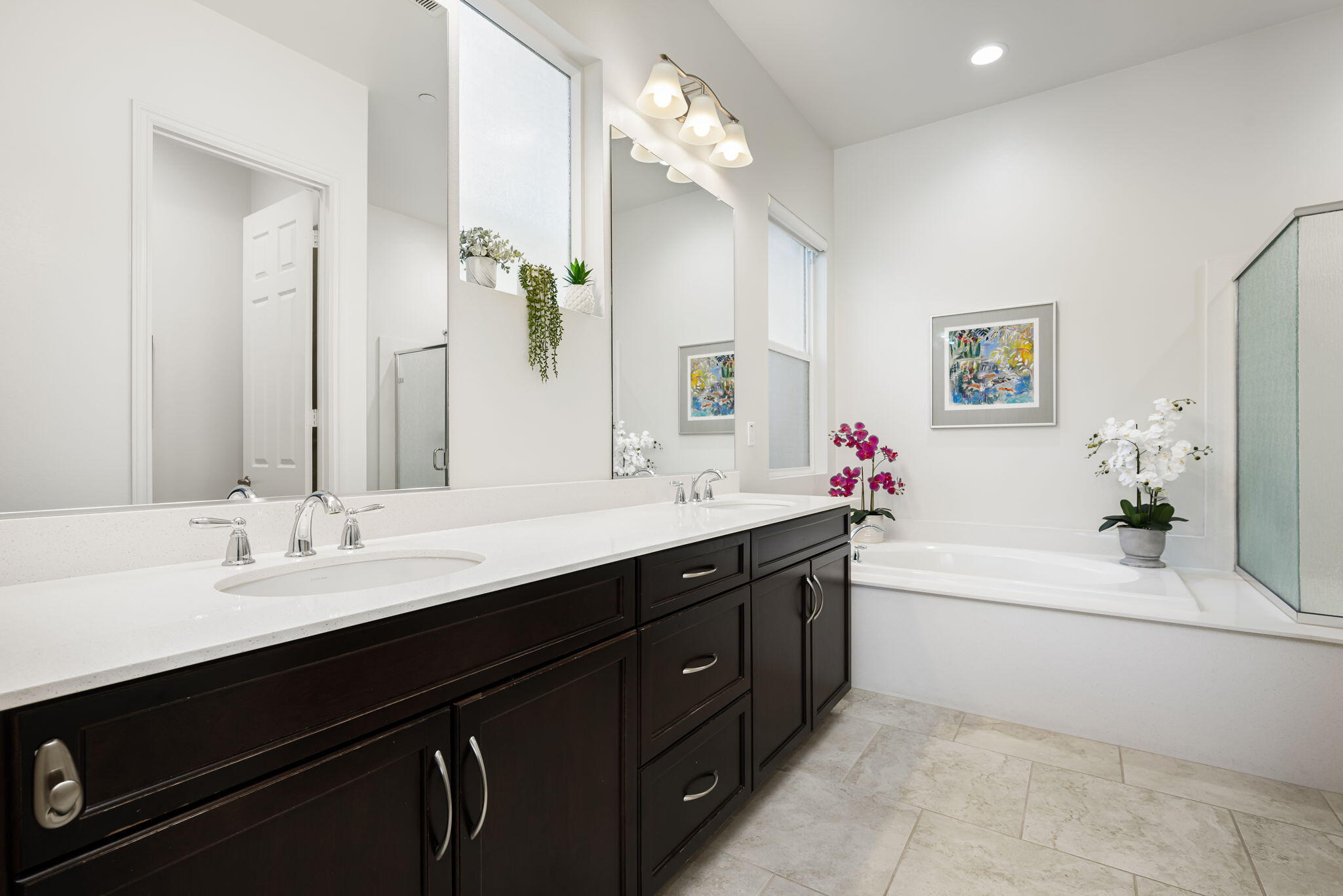 85568 Brovello Drive Indio, CA 92203 - Photo 24 of 50 a bathroom with a double vanity sink a large mirror and a bathtub