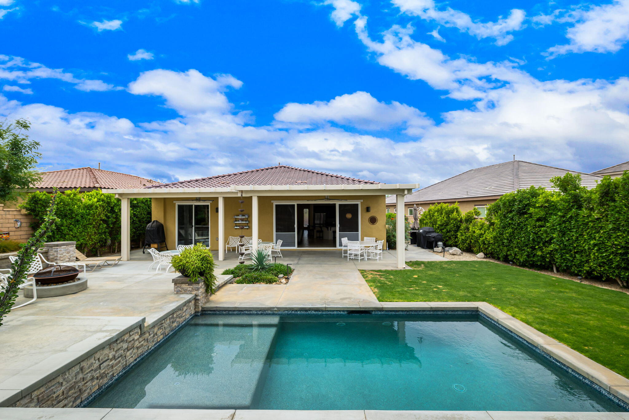 85568 Brovello Drive Indio, CA 92203 - Photo 30 of 50 a view of a house with swimming pool and sitting area