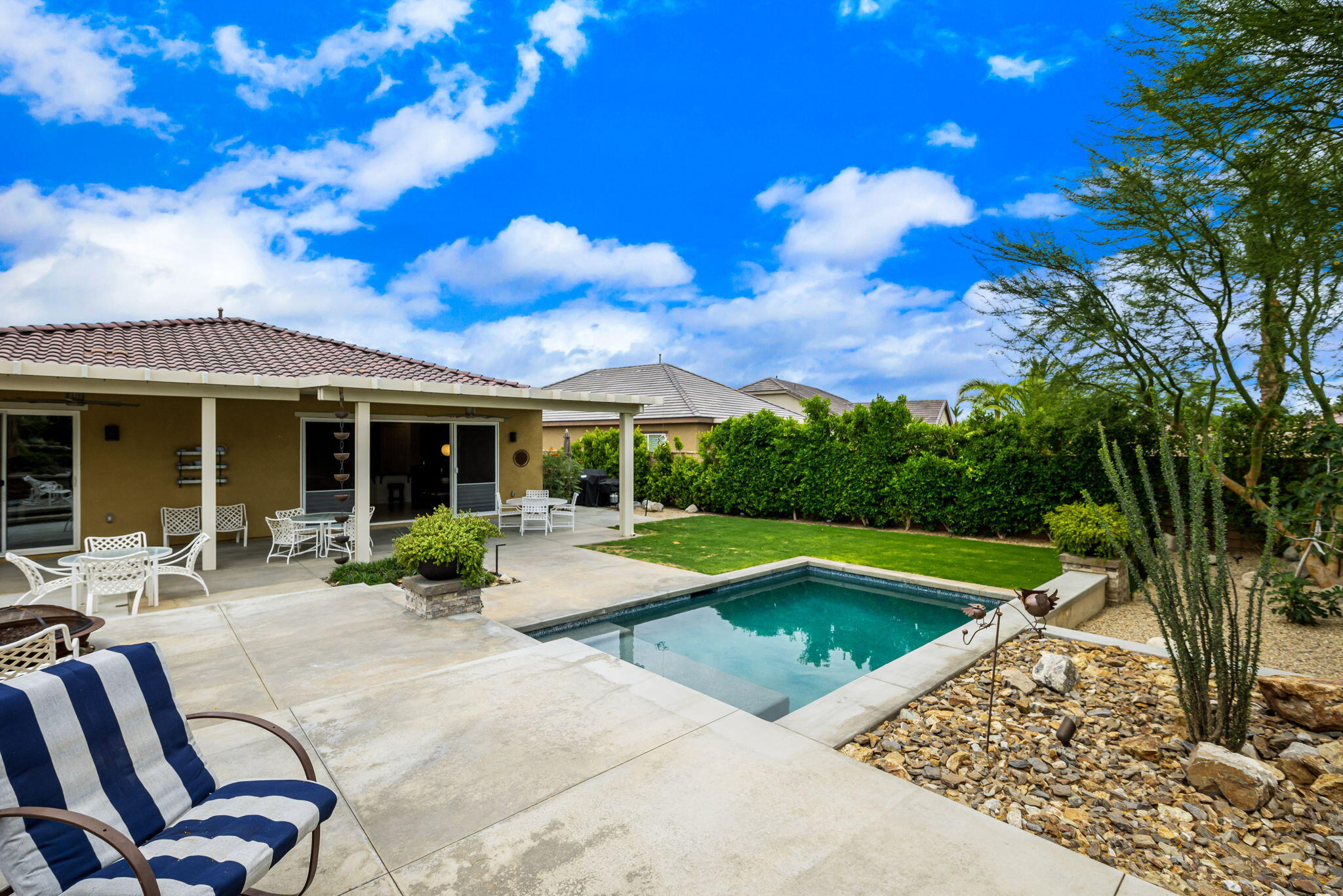 85568 Brovello Drive Indio, CA 92203 - Photo 33 of 50 a view of a house with swimming pool and sitting area