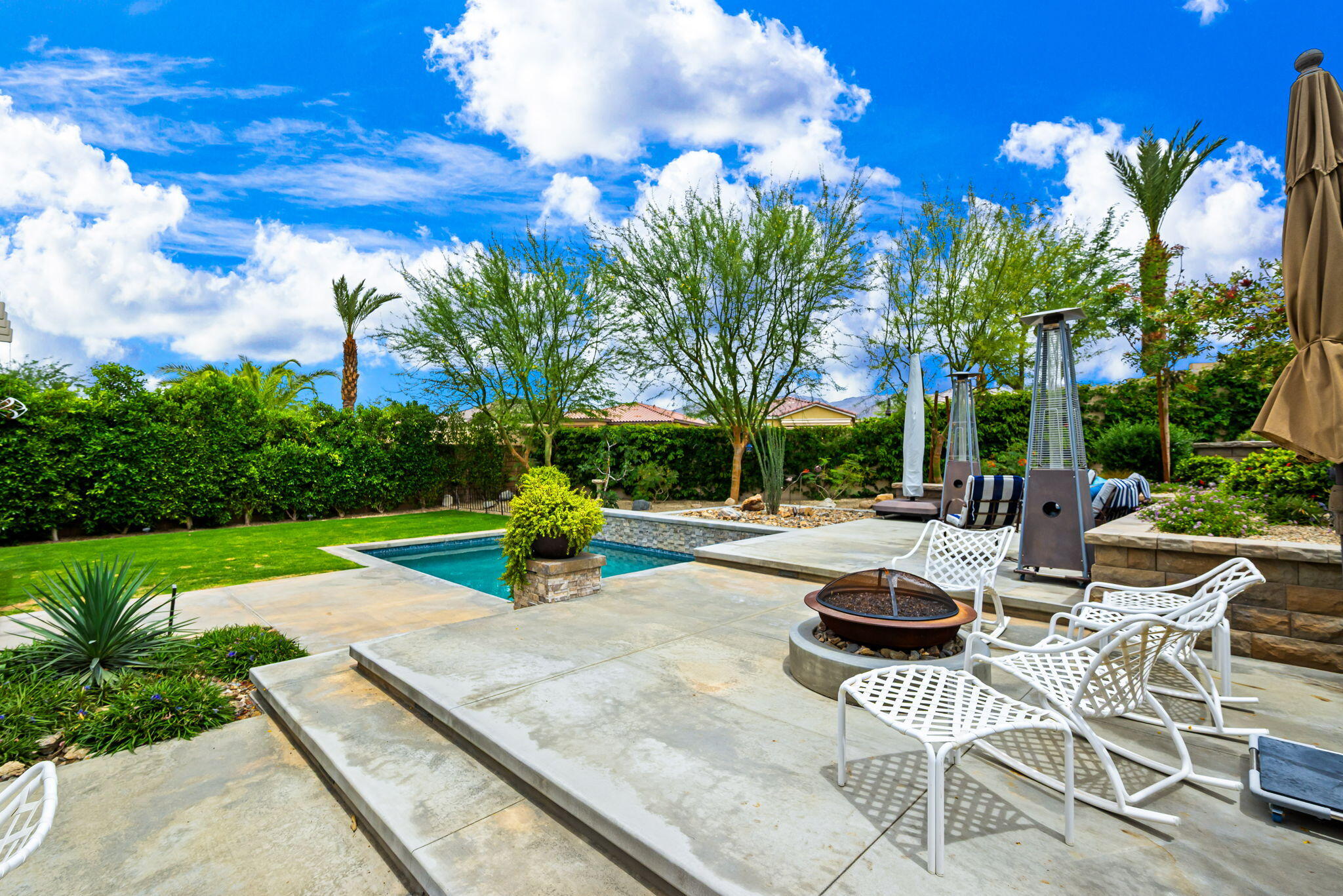 85568 Brovello Drive Indio, CA 92203 - Photo 35 of 50 a view of backyard with swimming pool and green space