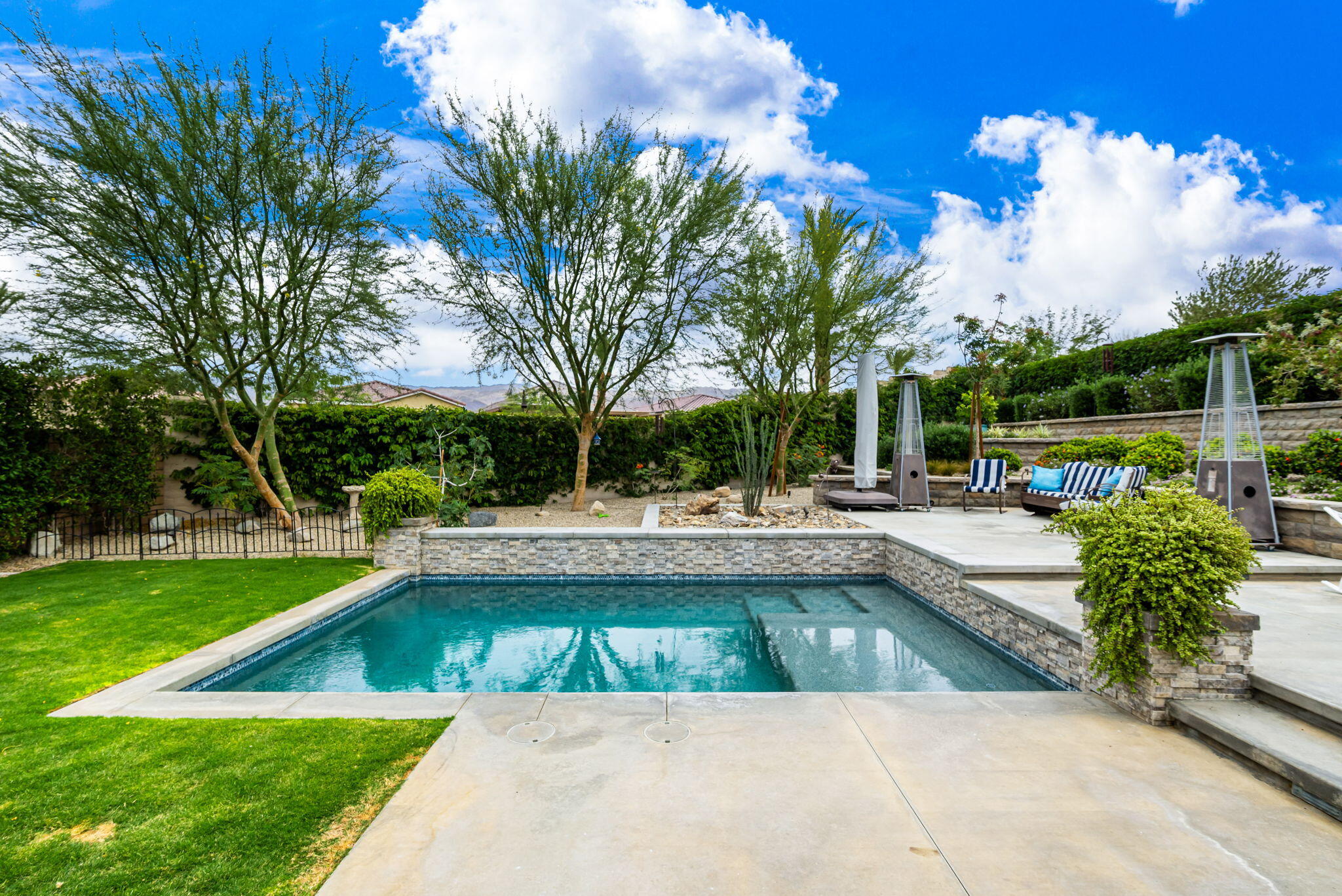 85568 Brovello Drive Indio, CA 92203 - Photo 38 of 50 a view of swimming pool with sitting area and garden