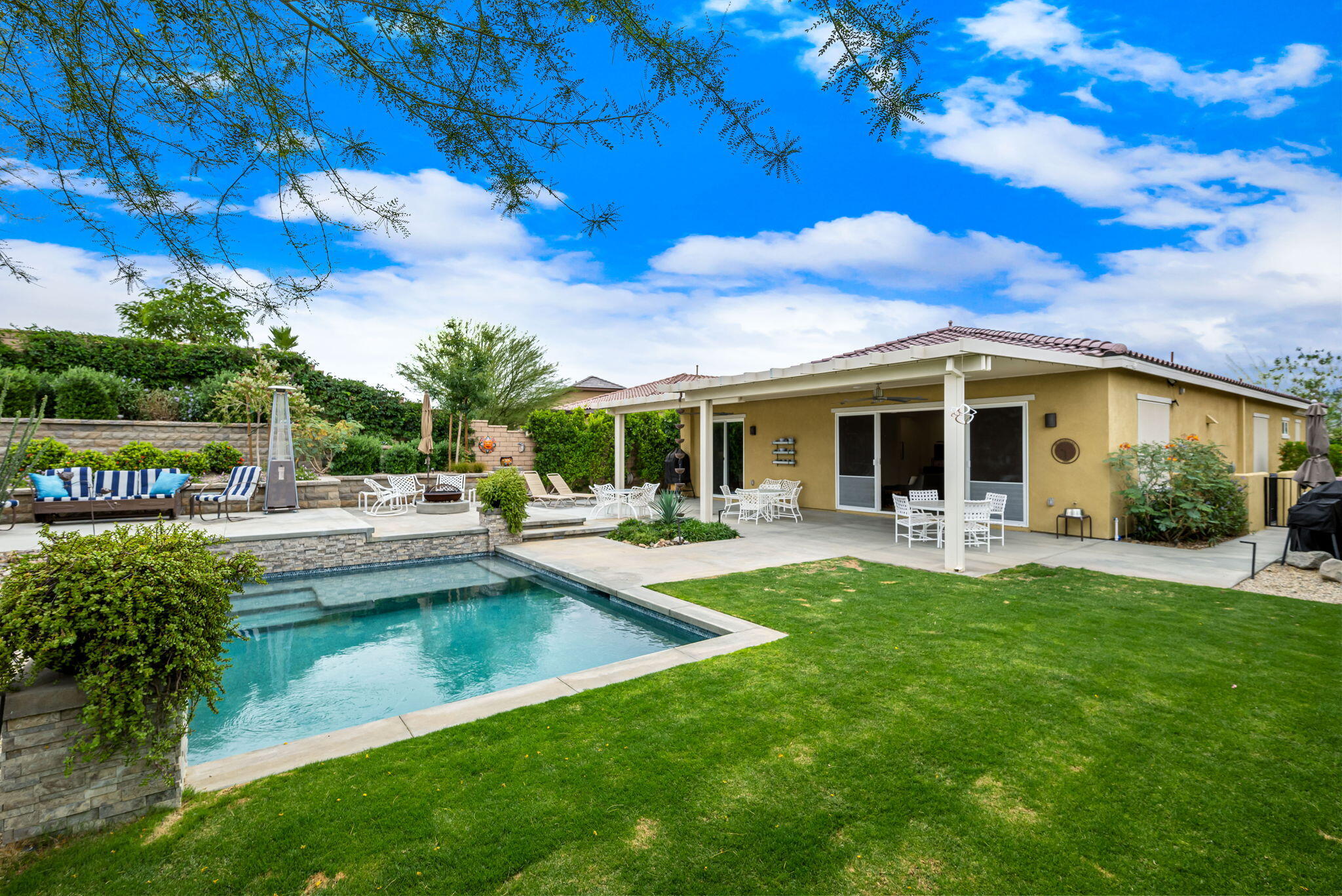 85568 Brovello Drive Indio, CA 92203 - Photo 39 of 50 a view of a house with swimming pool and sitting area