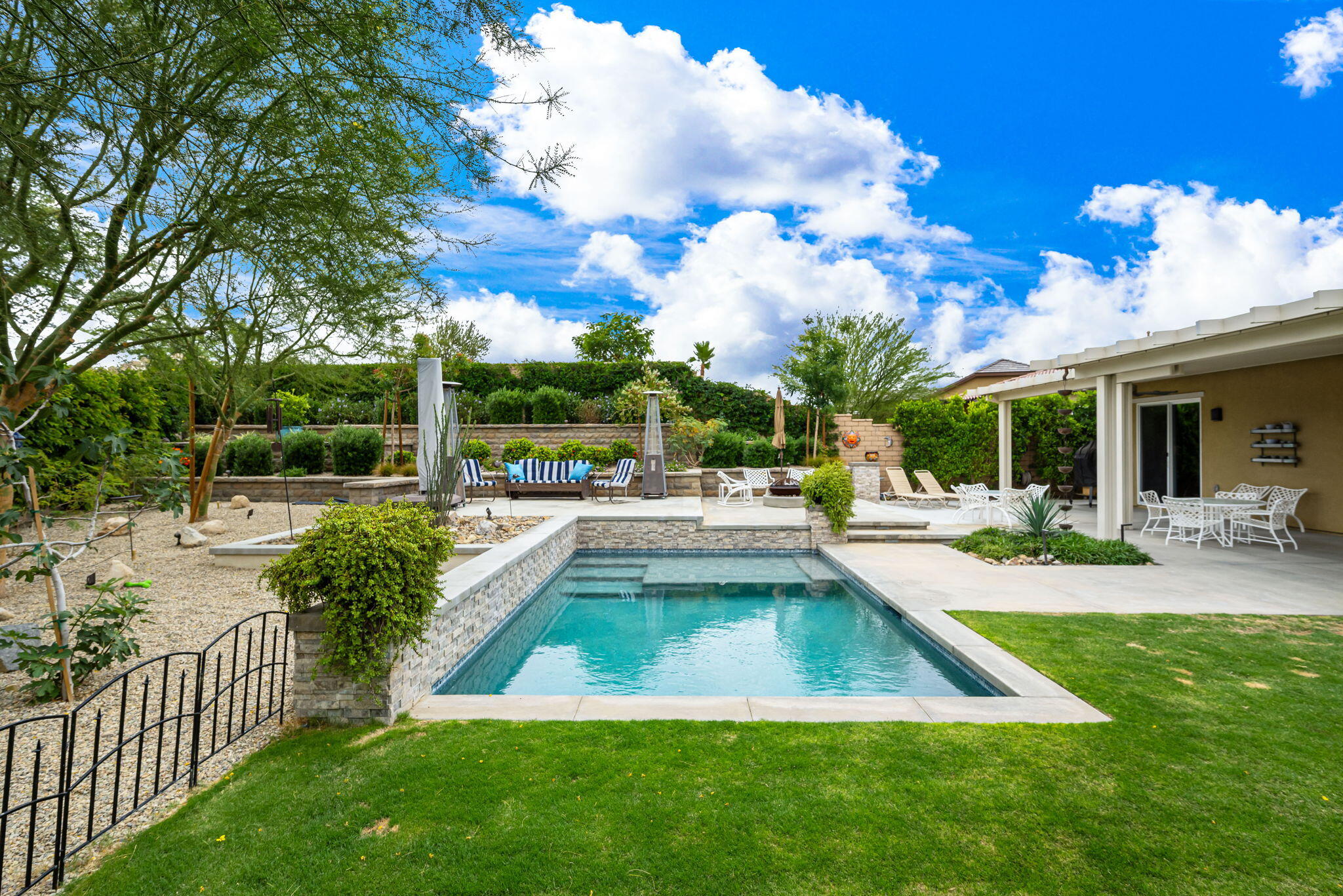 85568 Brovello Drive Indio, CA 92203 - Photo 40 of 50 a view of a house with swimming pool and sitting area