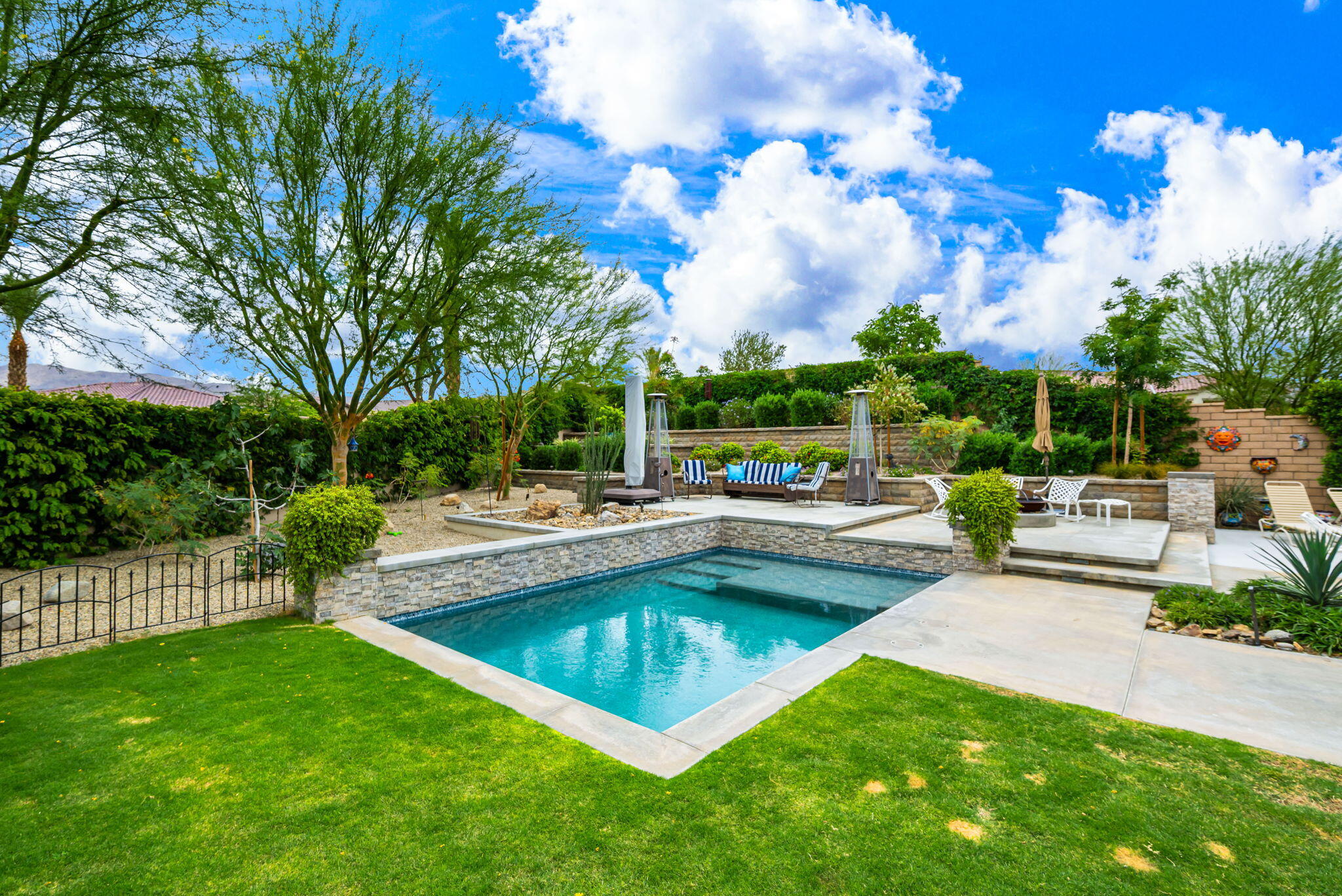 85568 Brovello Drive Indio, CA 92203 - Photo 41 of 50 a view of a swimming pool and sitting area