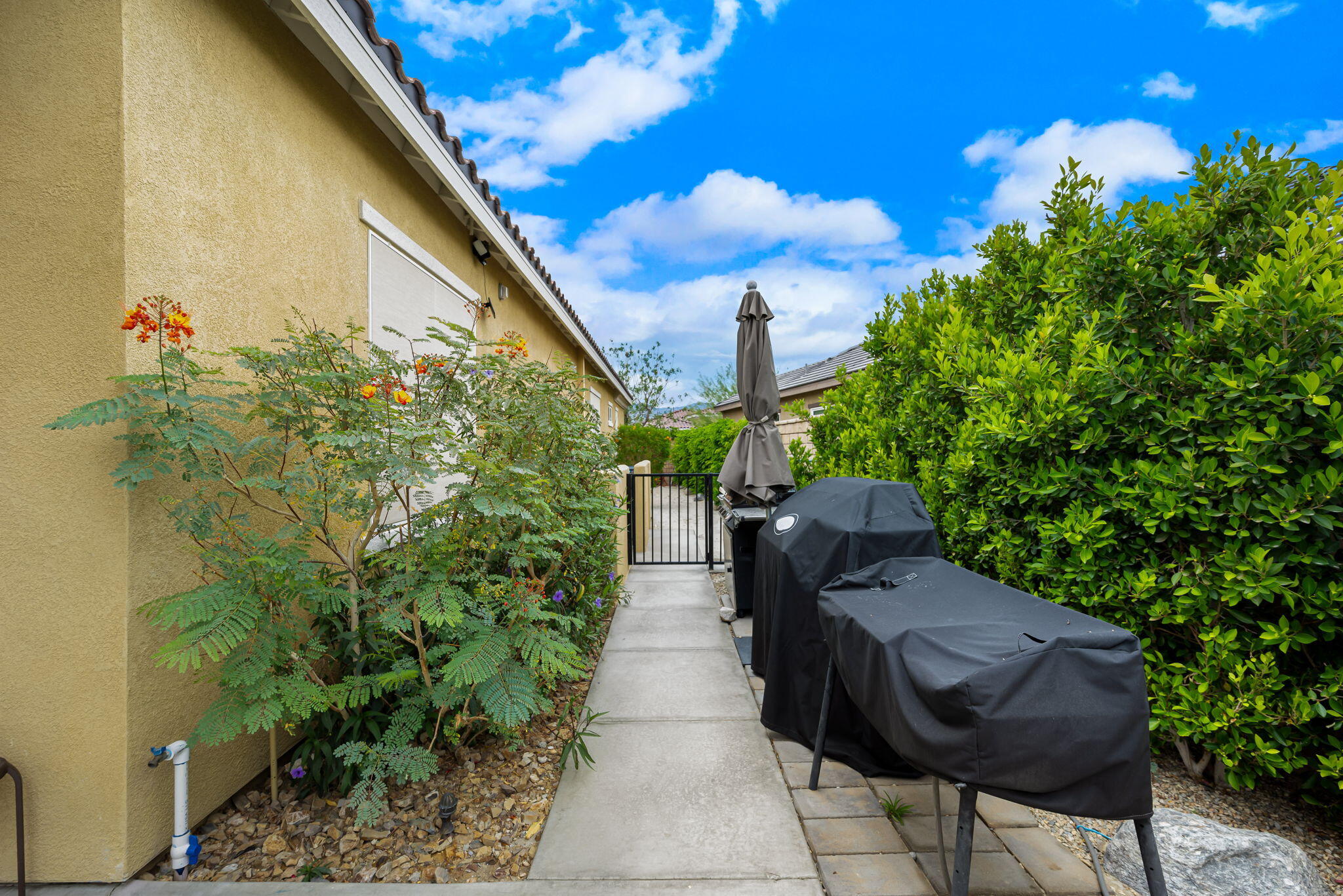 85568 Brovello Drive Indio, CA 92203 - Photo 45 of 50 a view of a chairs and table in the patio next to a yard
