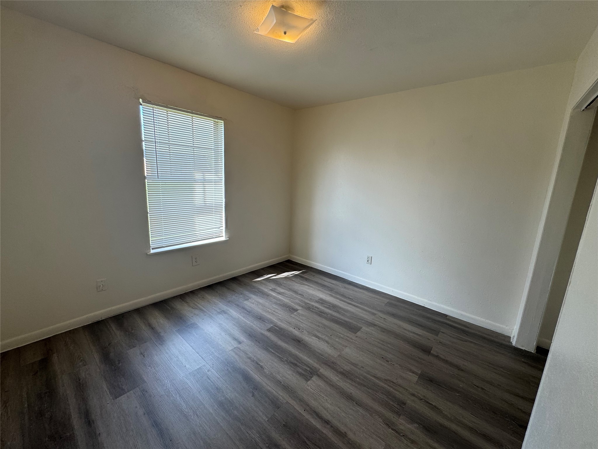 733 Pine Avenue Prairie View, TX 77445 - Photo 11 of 17 an empty room with wooden floor and windows