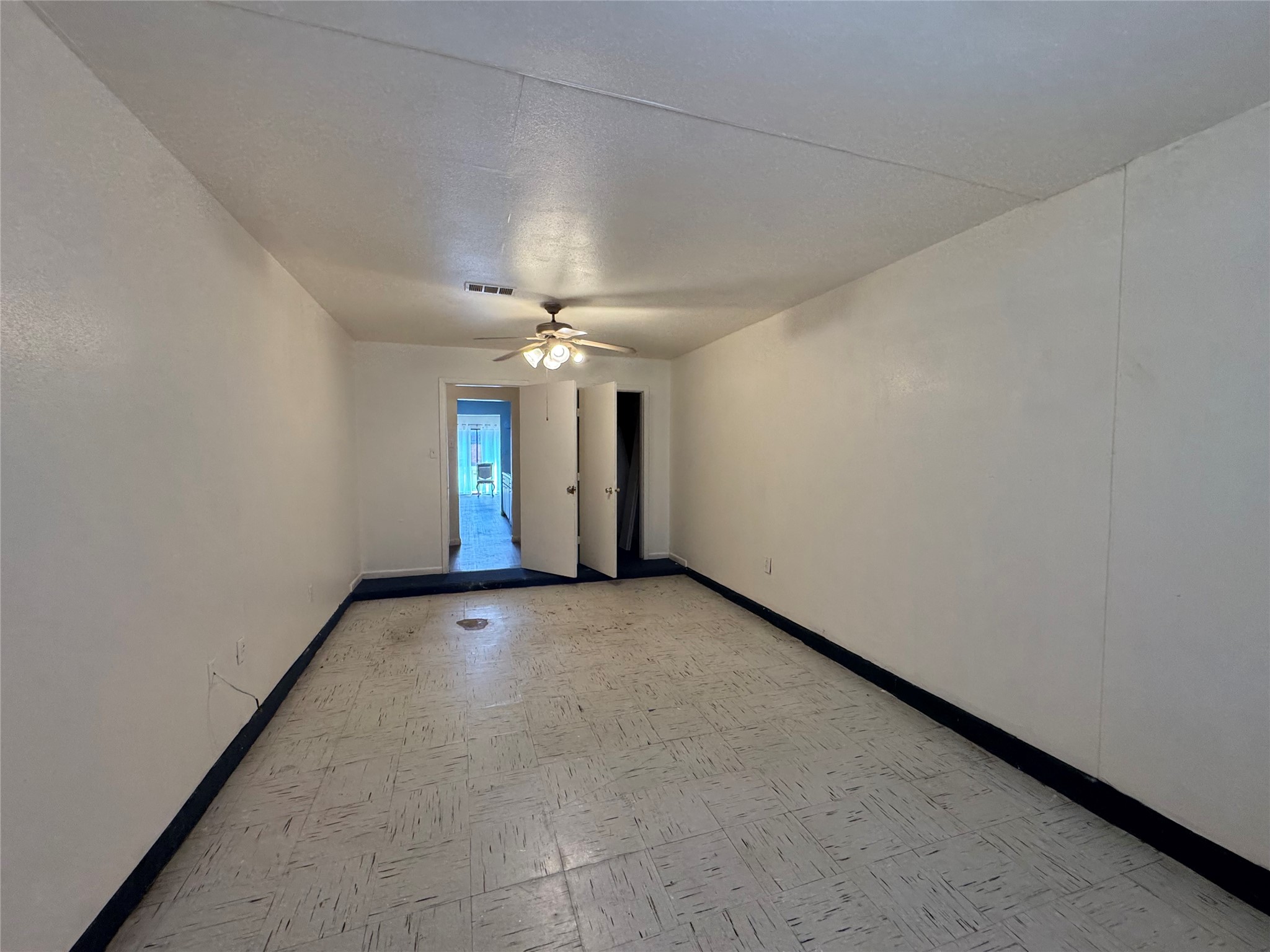 733 Pine Avenue Prairie View, TX 77445 - Photo 15 of 17 an empty room with chandelier fan and windows