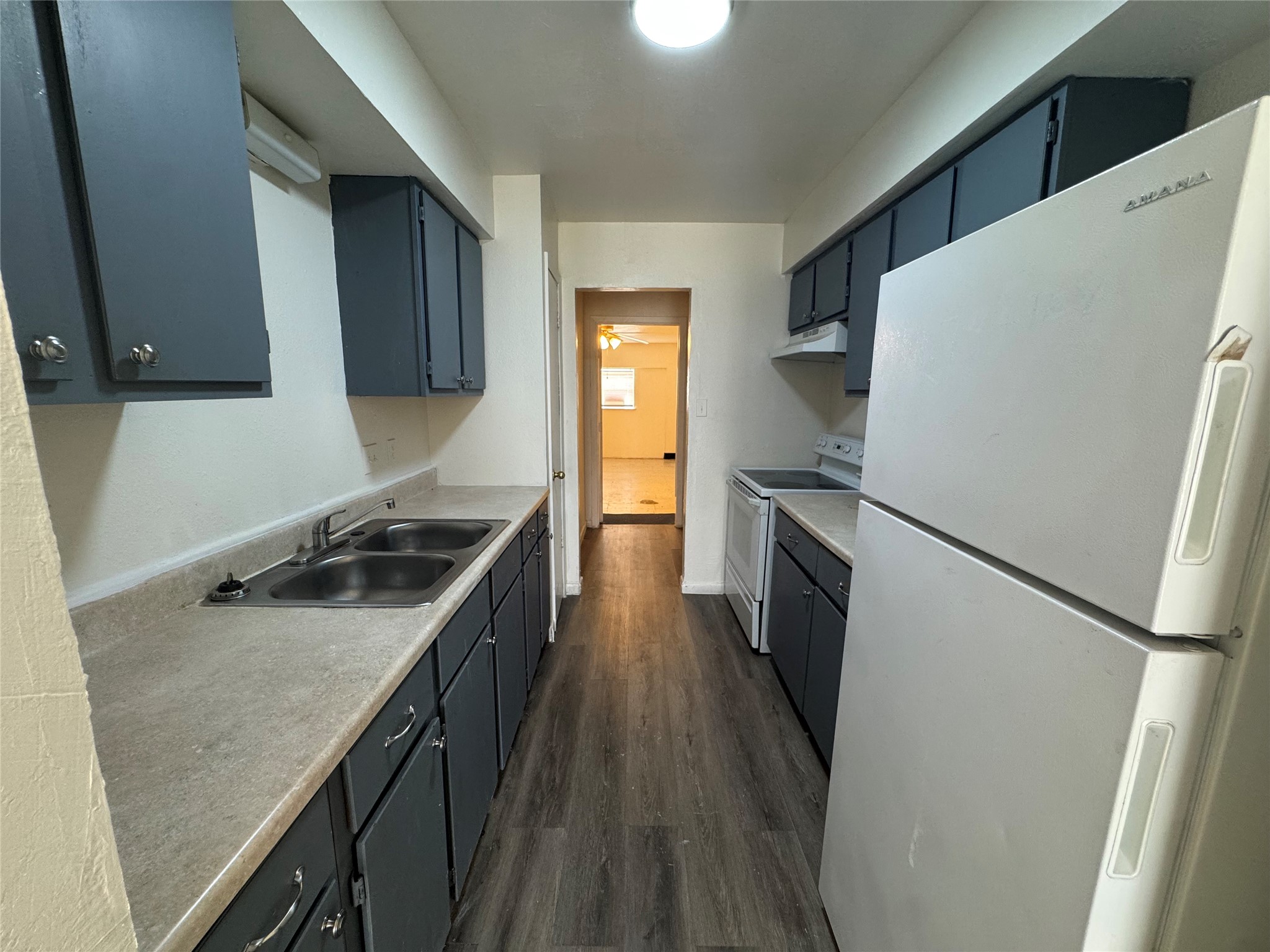 733 Pine Avenue Prairie View, TX 77445 - Photo 8 of 17 a kitchen with granite countertop a refrigerator a sink and wooden floor