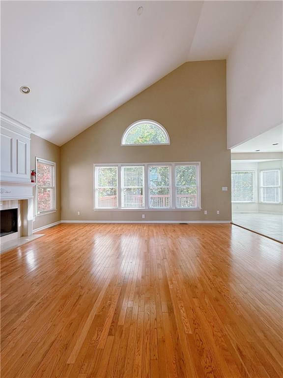 3332 Drawbridge Terrace Duluth, GA 30096 - Photo 11 of 28 an empty room with wooden floor fireplace and windows