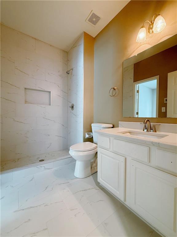 3332 Drawbridge Terrace Duluth, GA 30096 - Photo 12 of 28 a bathroom with a double vanity sink toilet and a mirror