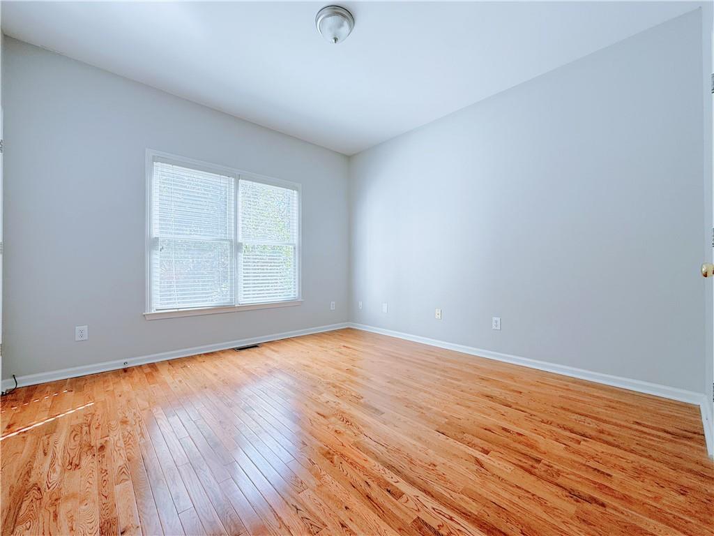 3332 Drawbridge Terrace Duluth, GA 30096 - Photo 14 of 28 an empty room with wooden floor and windows