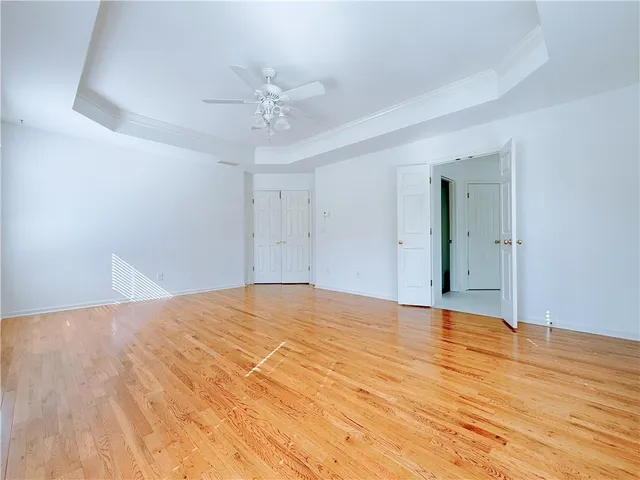 a view of empty room with wooden floor