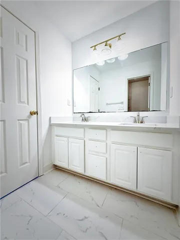 a spacious bathroom with a sink and a mirror