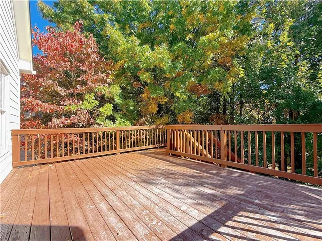 a view of balcony with wooden floor and fence