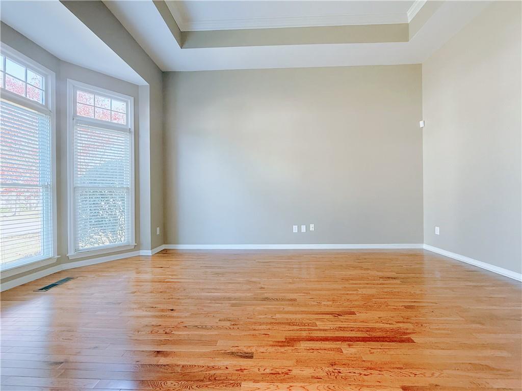 3332 Drawbridge Terrace Duluth, GA 30096 - Photo 4 of 28 a view of an empty room with wooden floor and a window