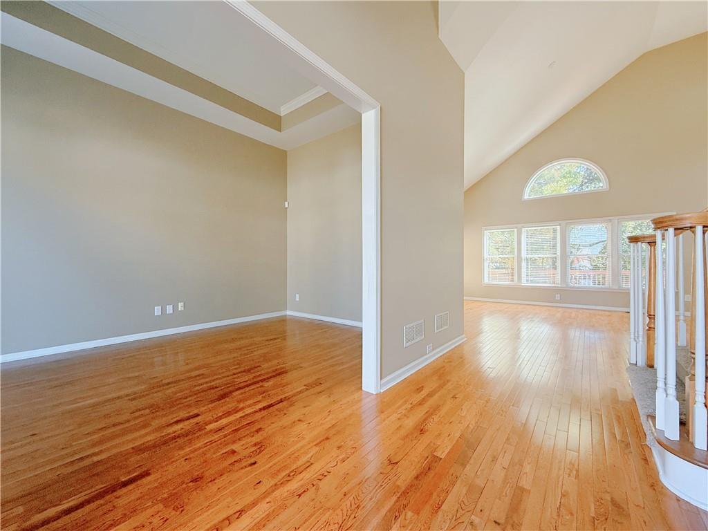 3332 Drawbridge Terrace Duluth, GA 30096 - Photo 6 of 28 wooden floor in an empty room with a window