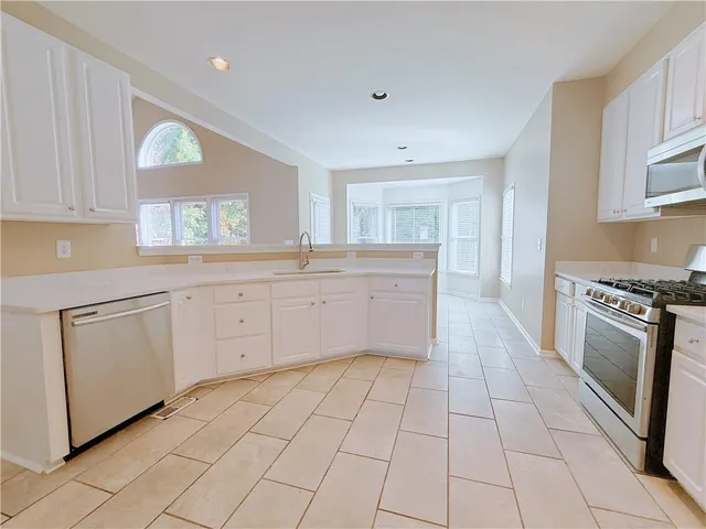 a kitchen with a stove a sink and a refrigerator