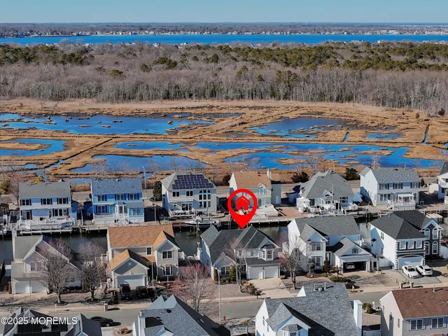 an aerial view of a house with a lake view
