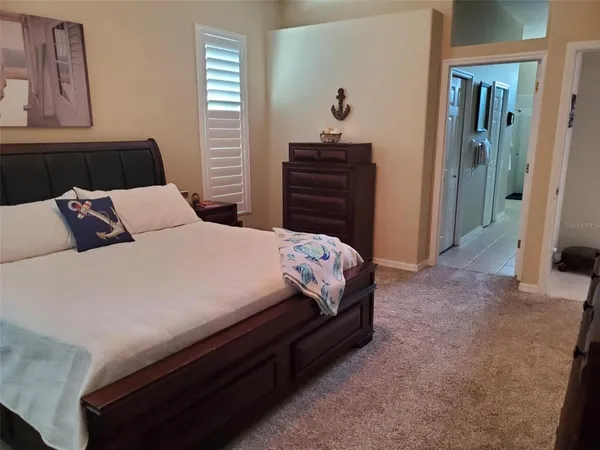 a bedroom with a bed and a mirror