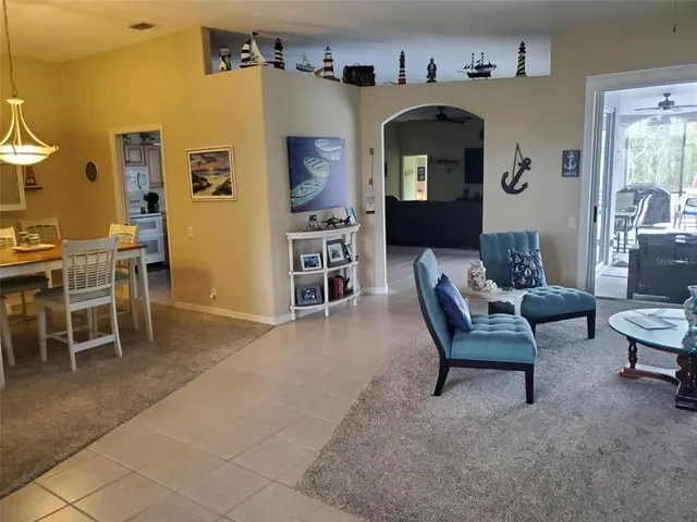 a living room with furniture and a dining table