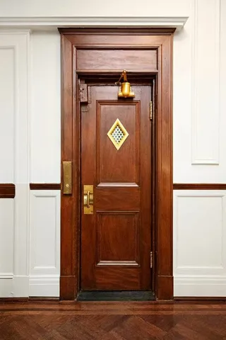 a living room with furniture a chandelier and a flat screen tv