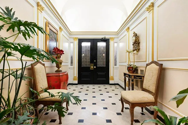 a living room with furniture and flowers