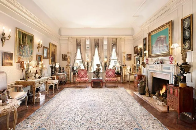 a living room with furniture large window and a fireplace