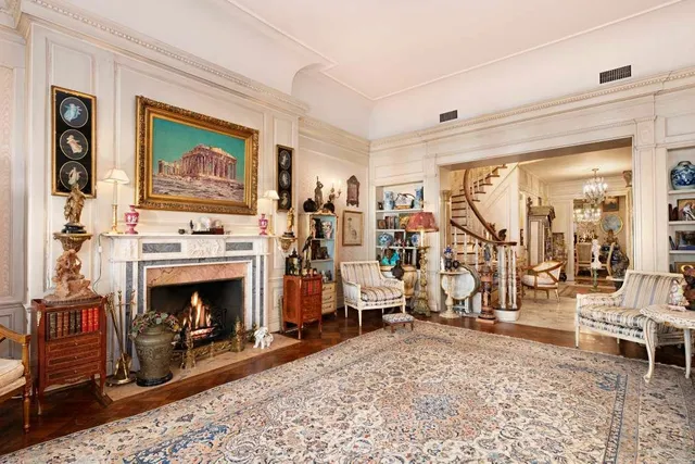 a living room with furniture a fireplace and a window