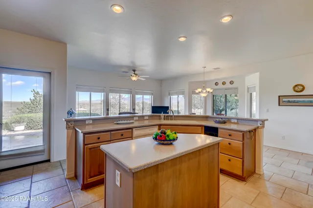 a dining room with furniture a chandelier and wooden floor