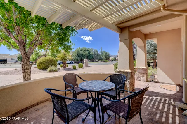 a view of balcony with table and chairs