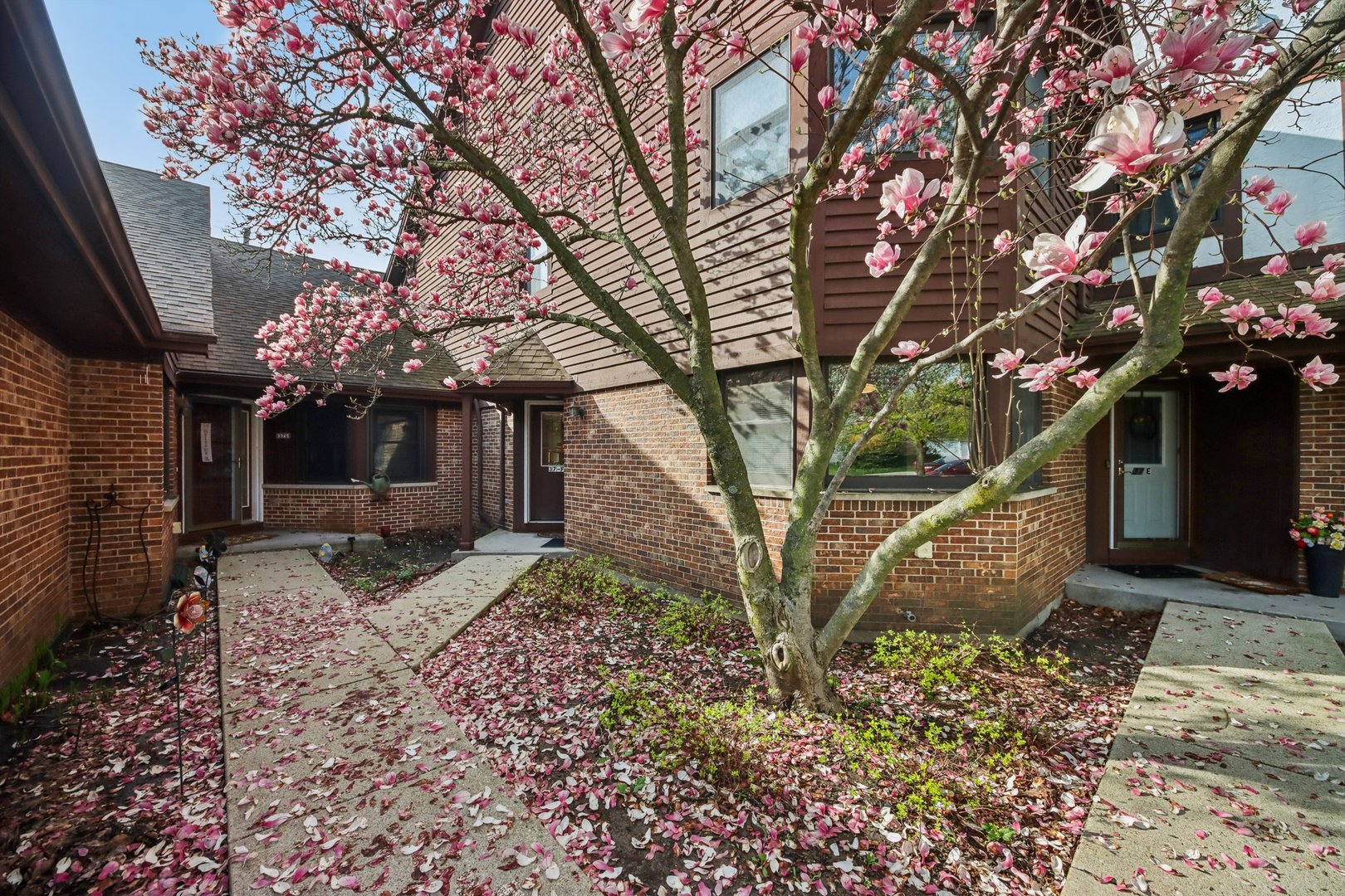37 Terrace Lane, Unit F Lake Zurich, IL 60047 - Photo 2 of 40 a front view of a house with garden