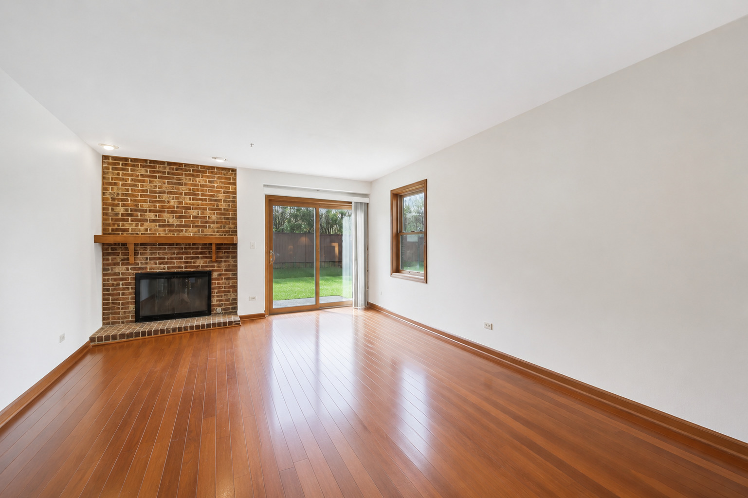 37 Terrace Lane, Unit F Lake Zurich, IL 60047 - Photo 6 of 40 a view of an empty room with glass door and wooden floor