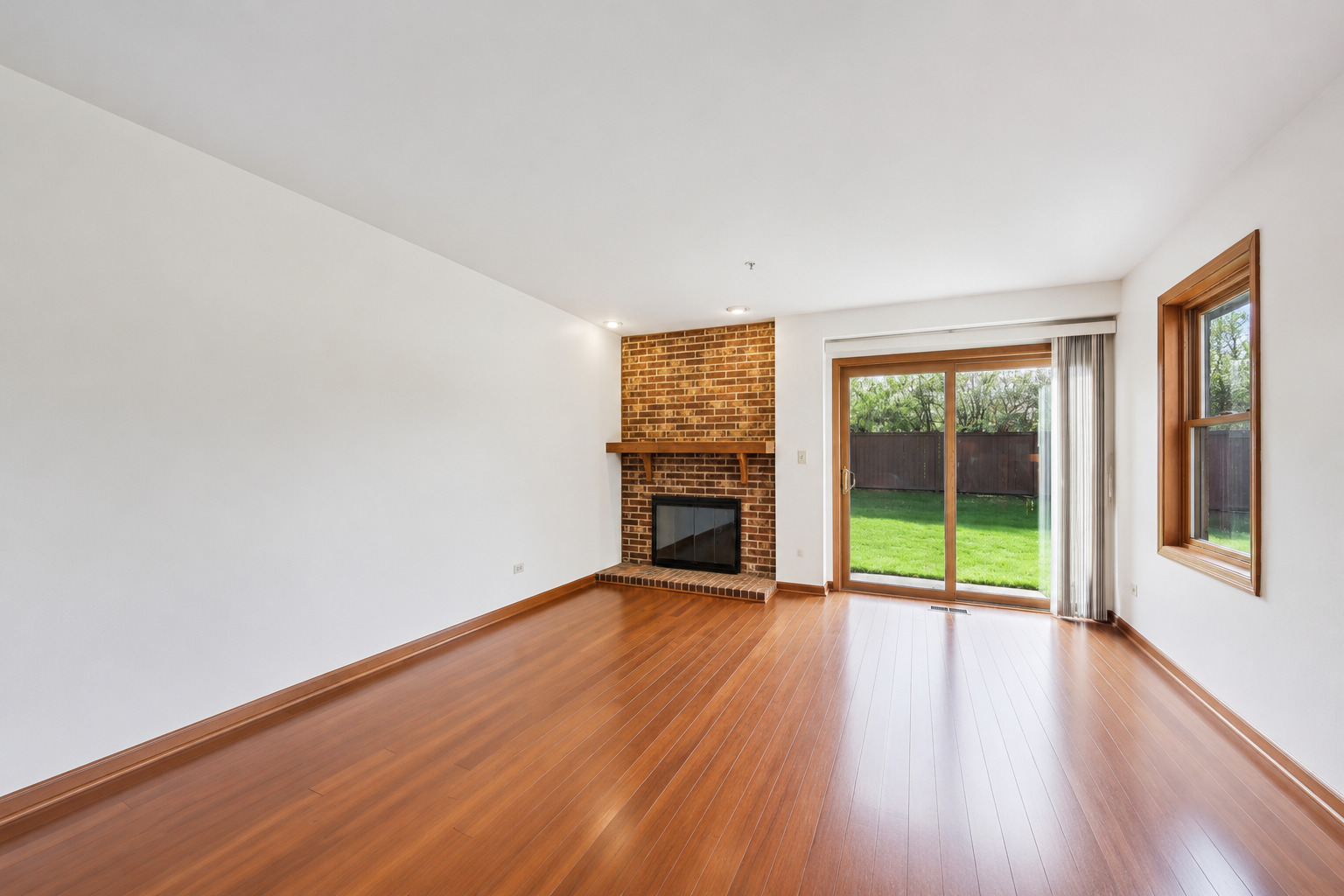 37 Terrace Lane, Unit F Lake Zurich, IL 60047 - Photo 8 of 40 wooden floor in an empty room with a window