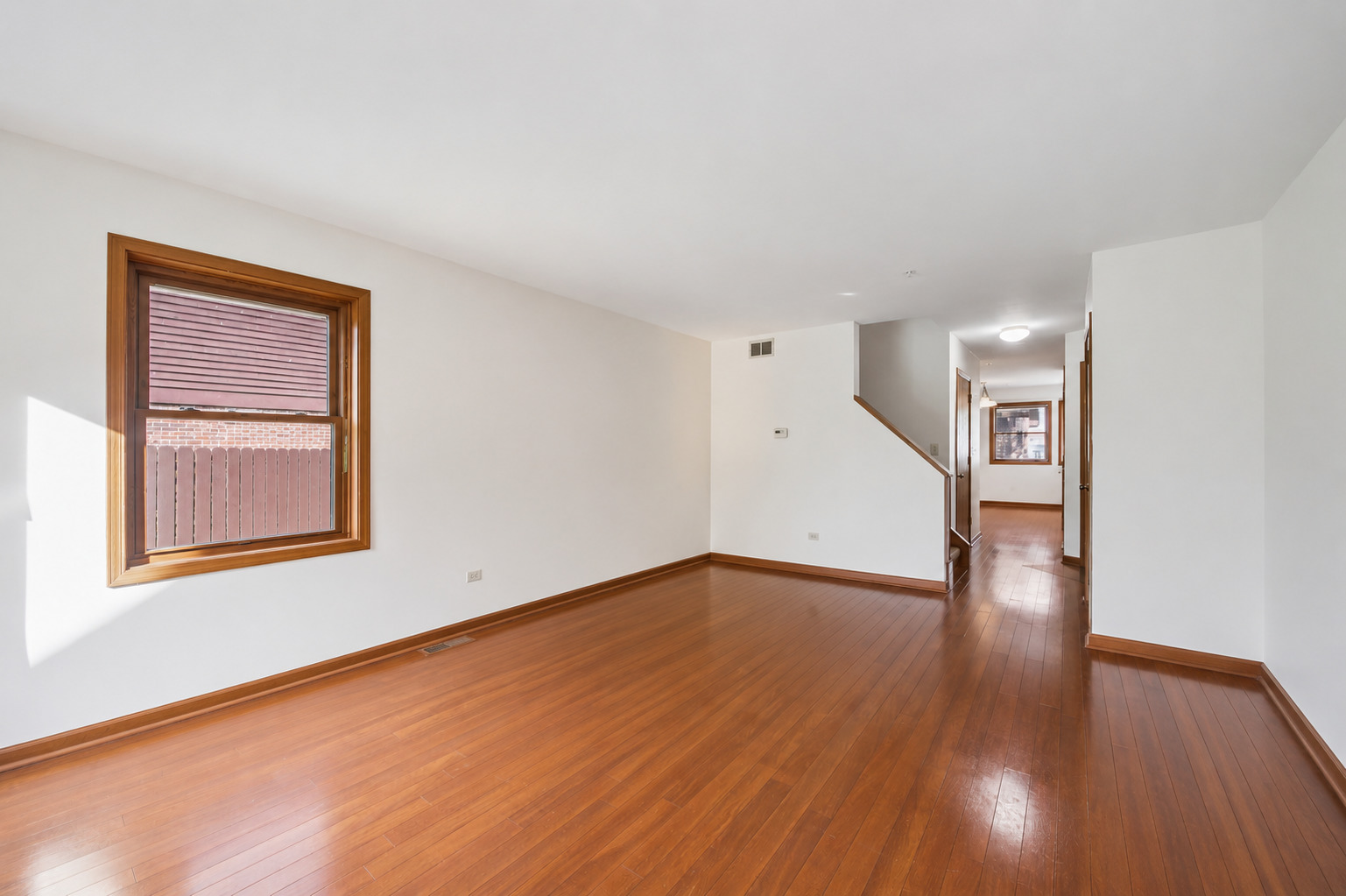 37 Terrace Lane, Unit F Lake Zurich, IL 60047 - Photo 10 of 40 a view of an empty room with wooden floor and a window