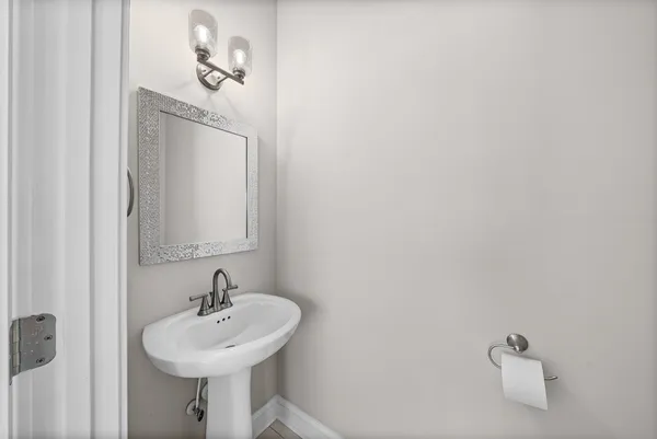 a bathroom with a sink a mirror and vanity