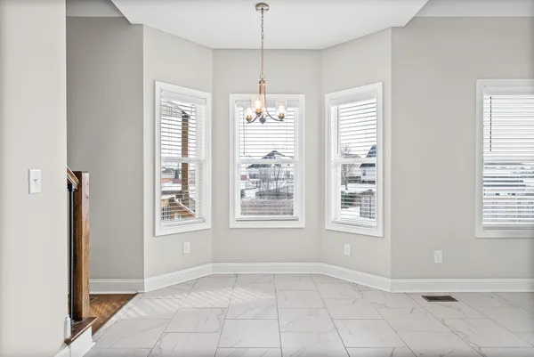 an empty room with windows and entrance