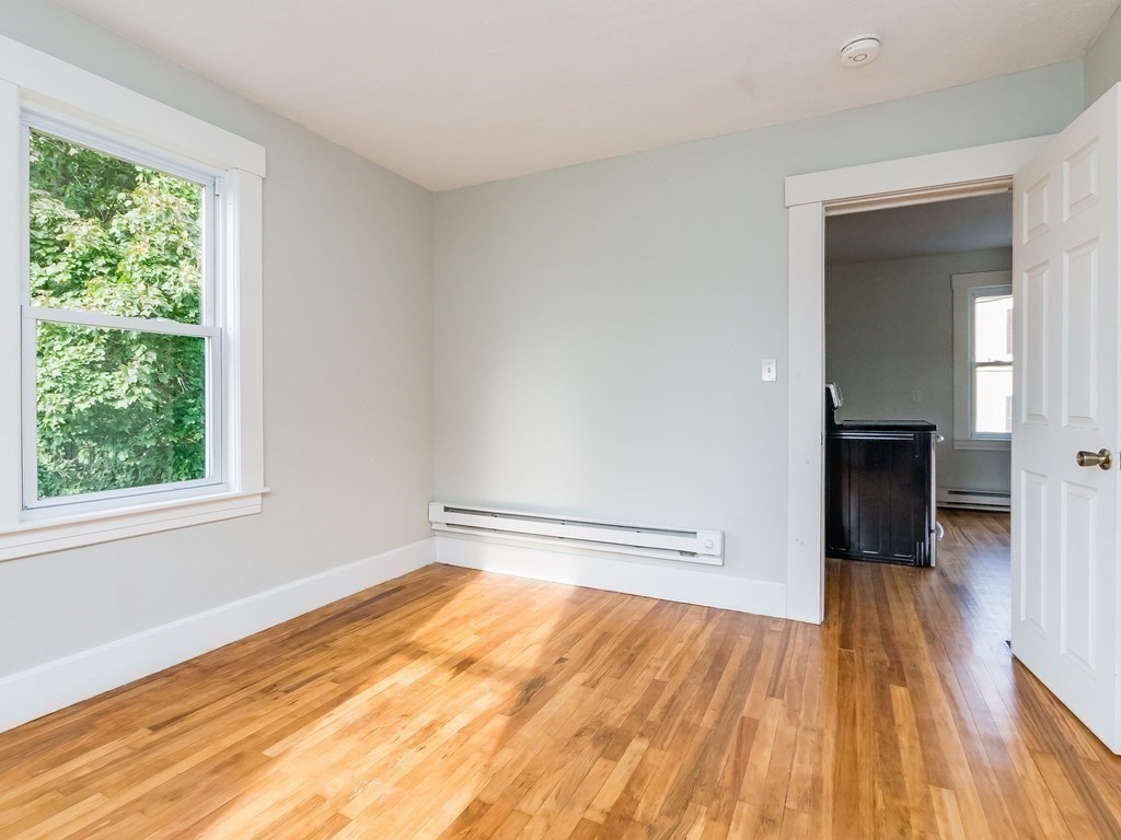 133 Baker Street Gardner, MA 01440 - Photo 8 of 10 a view of empty room with wooden floor and fan