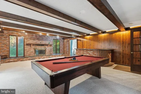 a room with pool table and windows