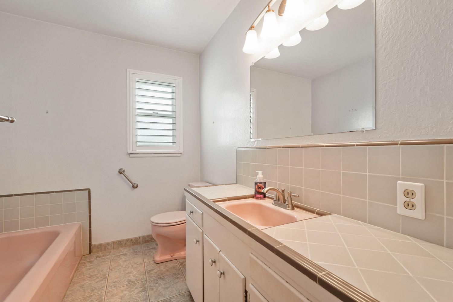 1007 Cardinal Street Lodi, CA 95240 - Photo 15 of 31 a bathroom with a sink a toilet and bathtub