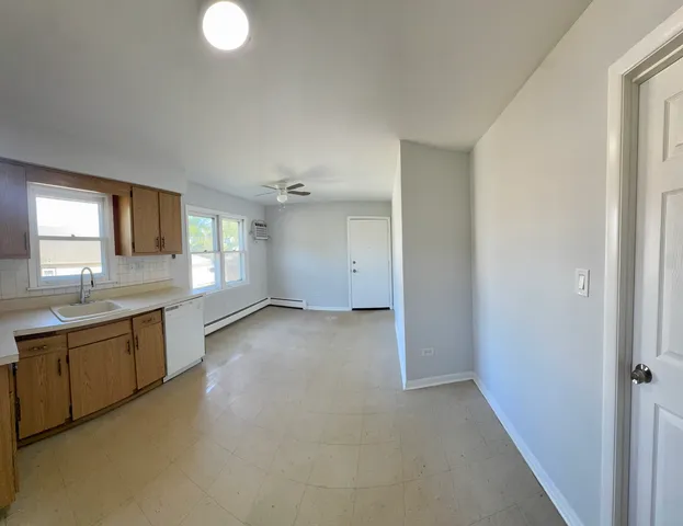 a view of a kitchen with a sink and window