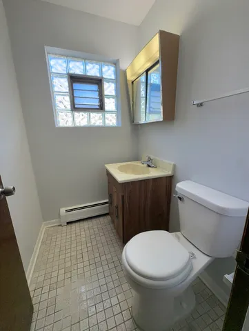 a bathroom with a sink a toilet and mirror